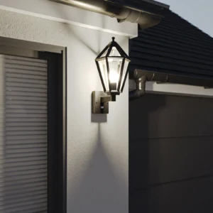 Matt black PIR motion sensor outdoor lantern wall light mounted on a white exterior wall next to a window