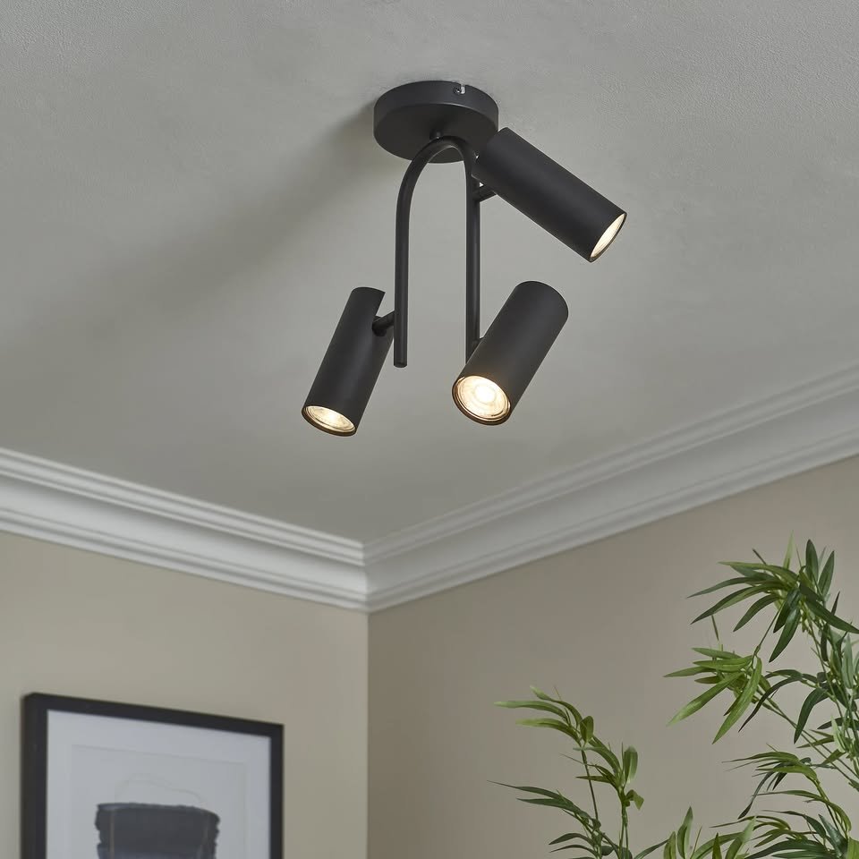 Modus 3-Light Matt Black Ceiling Spotlight with three adjustable cylindrical lights mounted on a ceiling
