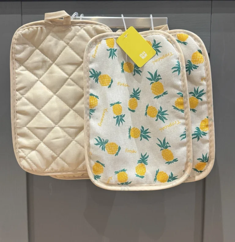 Set of heat resistant oven mitts pot holders for kitchen, one plain beige and two with pineapple print