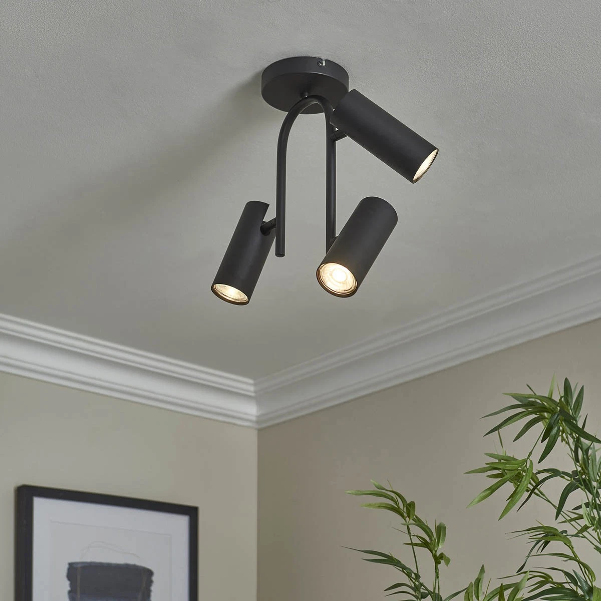 Modus 3-light matt black ceiling spotlight with adjustable cylindrical heads mounted on ceiling