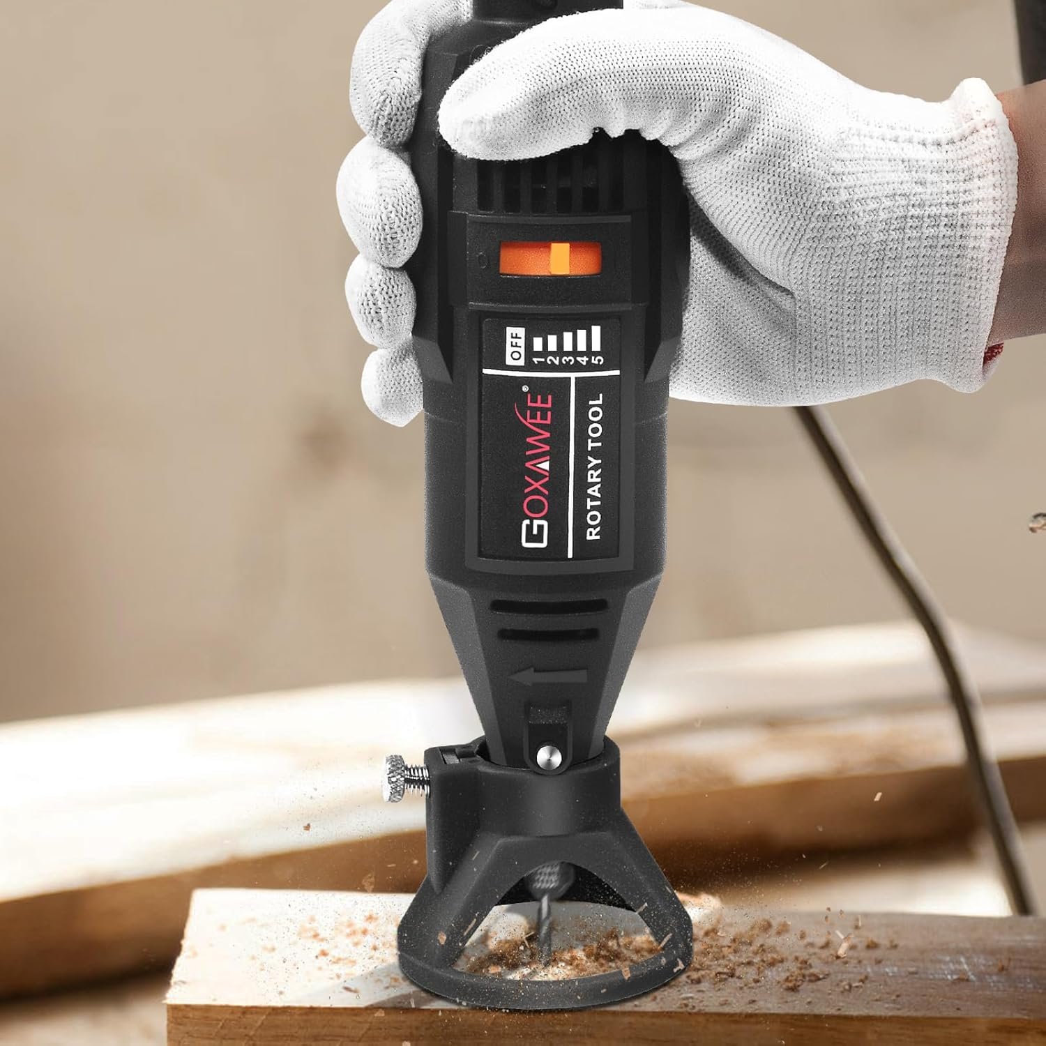 Rotary tool kit in use drilling into wood, showing black and red GOXAWEE multi-functional mini grinder.