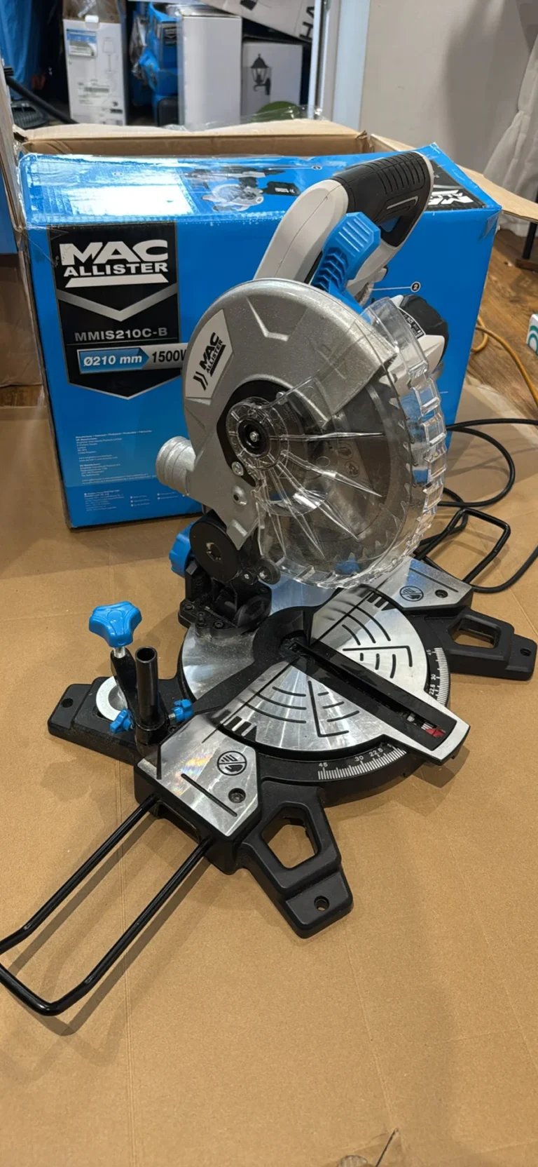 miter saw with silver metal blade, black and blue plastic components