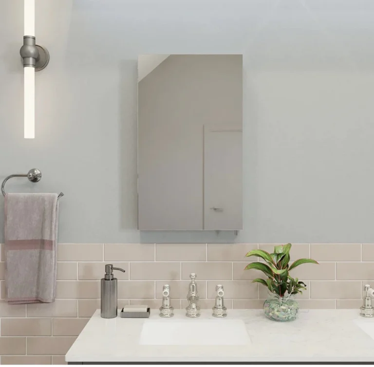 Bathroom sink with two metal faucets, rectangular mirror