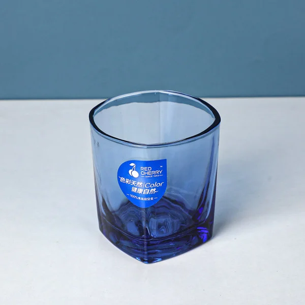 Blue glass with hexagonal base and label featuring blue and white text