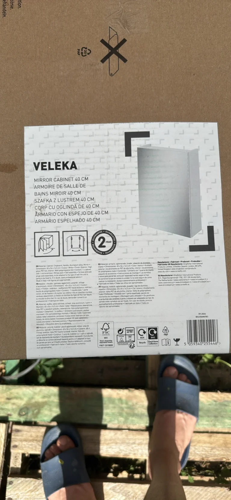 Cardboard packaging with a printed image of a brown and white mirror
