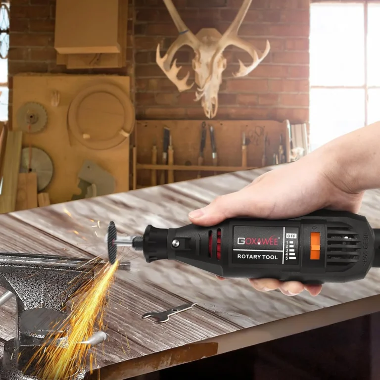 rotary tool in use emitting sparks, black and red with textured grip